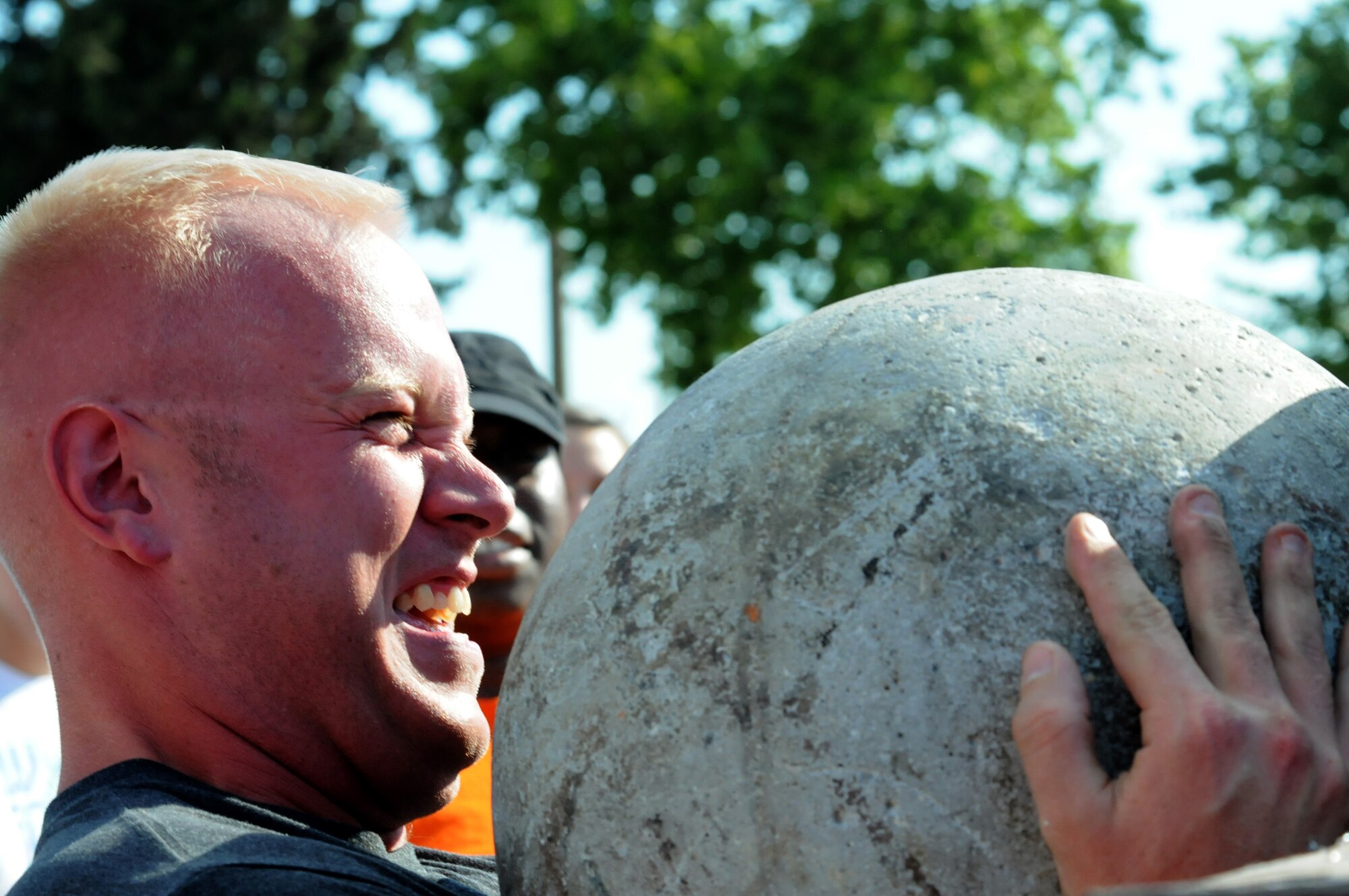 A contestant attempts to lift a 200-pound boulder onto a platform during the Strongman Competition July 4, 2012, at Incirlik Air Base, Turkey. The competition was part of the Independence Day activities sponsored by the 39th Force Support Squadron and was followed by a concert and fireworks. (U.S. Air Force photo by Senior Airman Marissa Tucker/Released)