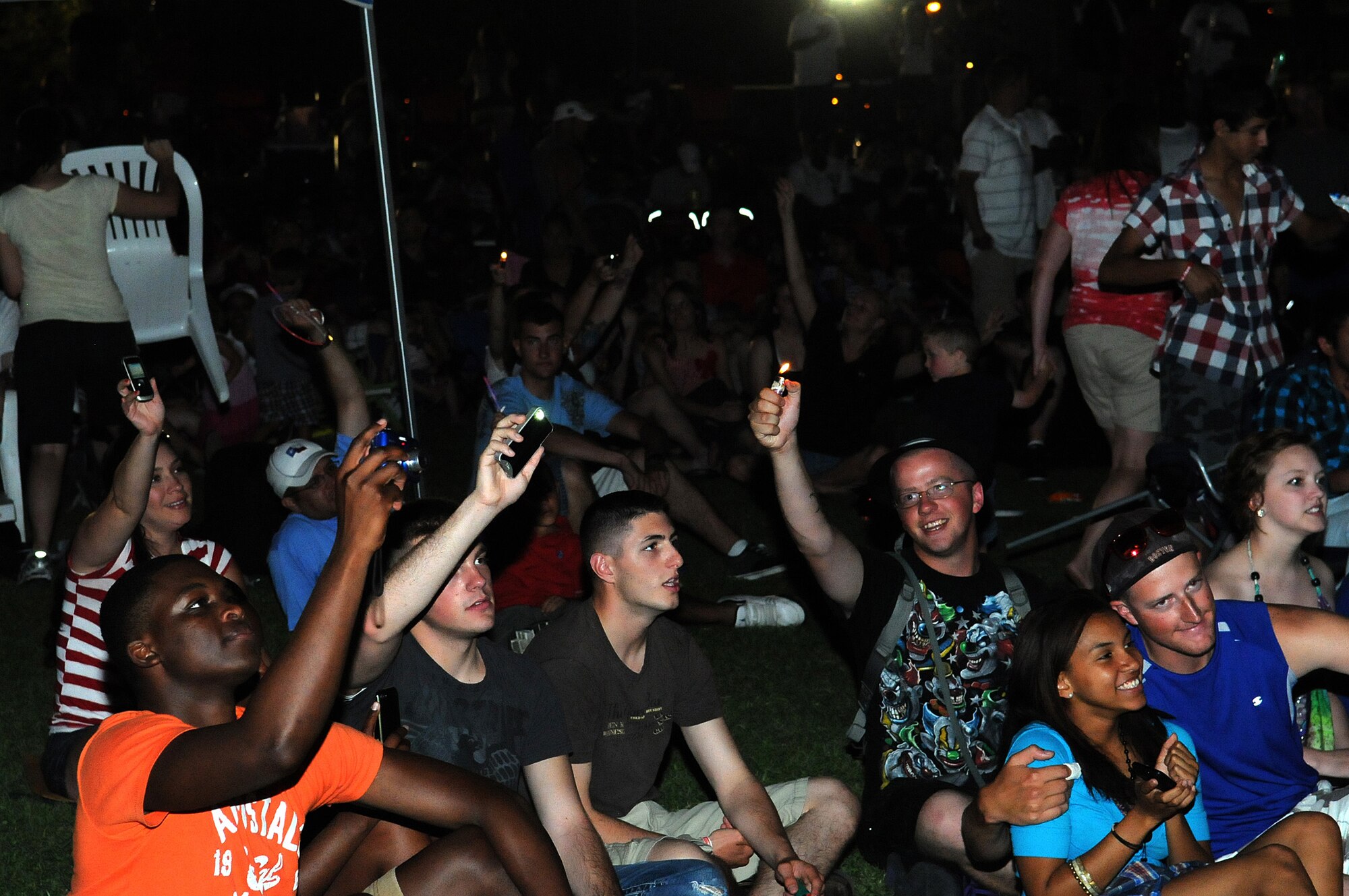 Members of the audience wave cell phones and lighters during the American Idol Tour concert at the Independence Day celebration July 4, 2012, at Incirlik Air Base, Turkey. Members of the tour performed several popular songs for attendees of the event. (U.S. Air Force photo by Senior Airman Marissa Tucker/Released)