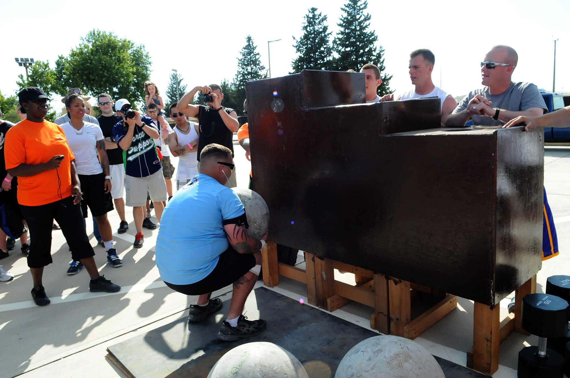 A member of the U.S. Army attempts to lift a 180-pound boulder during the Strongman Competition July 4, 2012, at Incirlik Air Base, Turkey. The competition was part of the Independence Day activities sponsored by the 39th Force Support Squadron and was followed by a concert and fireworks. Members of the U.S. Army who are temporarily stationed at Incirlik participated in the events to build camaraderie on the holiday.  (U.S. Air Force photo by Senior Airman Marissa Tucker/Released)