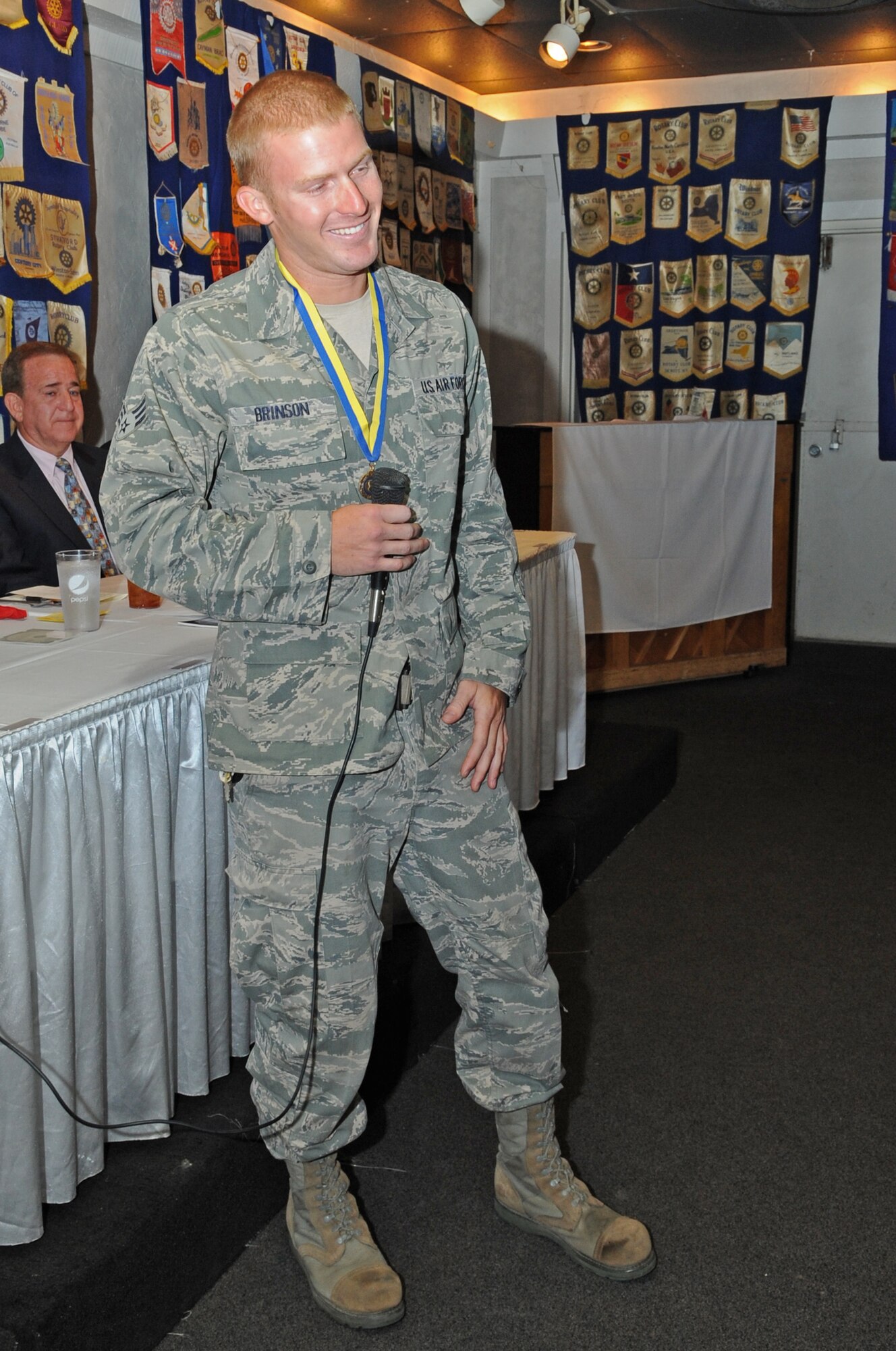 U.S. Air Force Senior Airman Ashton Brinson delivers an acceptance speech at the Rotary Club in Kinston, N.C., June 28, 2012. According to the club, the Paul Harris Fellow is normally given to those who contribute substantially to the Rotary Club’s humanitarian and educational programs however, Brinson was presented with the award because he lives by their motto of “Service above Service.” Brinson, 567th RED HORSE Squadron vehicle maintainer, hails from Lenoir County, N.C. (U.S. Air Force photo/Airman 1st Class Aubrey Robinson/Released)