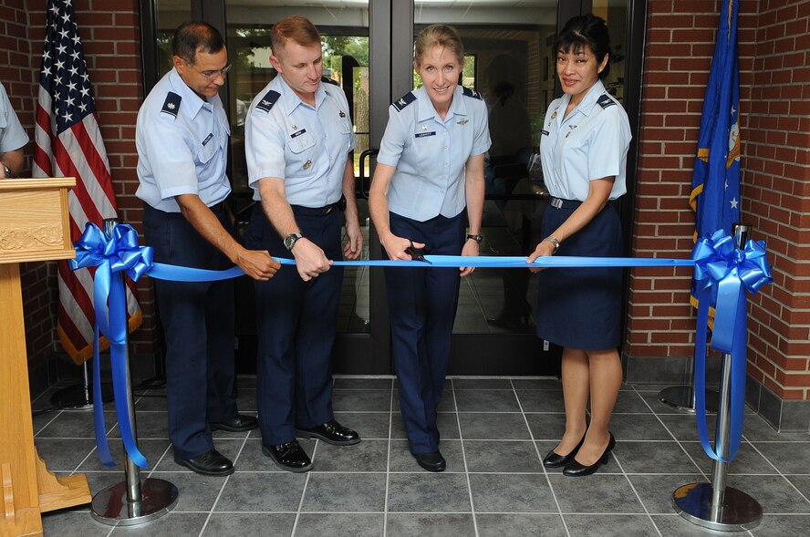 U.S. Air Force Col. Jeannie Leavitt cuts a ribbon during the re-opening ceremony of the Family Life Center on Seymour Johnson Air Force Base, N.C., July 2, 2012. In 2011, an expansion was approved to add 3,000 square feet to provide more classrooms, larger conference rooms and office space for the Family Advocacy team to relocate. Leavitt is the 4th Fighter Wing commander. (U.S. Air Force photo/Airman 1st Class Aubrey Robinson/Released)