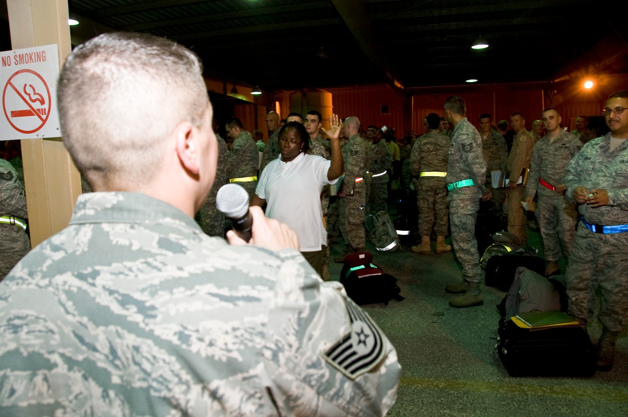 Technical Sgt. Adrian Salas, 379th Expeditionary Force Support Squadron PERSCO reception control center member, gives detailed instructions of procedures new arrivals must adhere to when processing through customs July 5, 2012 in Southwest Asia. PERSCO accounts for 100 percent of people that come through here, regardless of their length of stay and ensures a smooth transition through immigrations and customs. (U.S. Air Force photo/Senior Airman Bryan Swink)