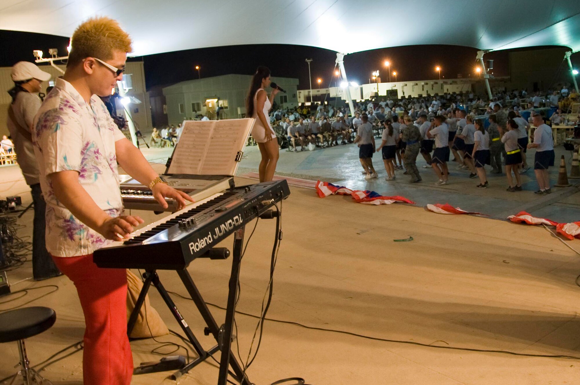 Soul Cafe, an R&B cover band, performed for a packed house at Memorial Plaza while service members danced in celebration of the July 4th celebration in Southwest Asia. The Independence Day's festivities also included a 5K run, steak grilling, stand-up comedians and a Biggest Splash Contest. (U.S. Air Force photo/Staff Sgt. Sheila deVera)