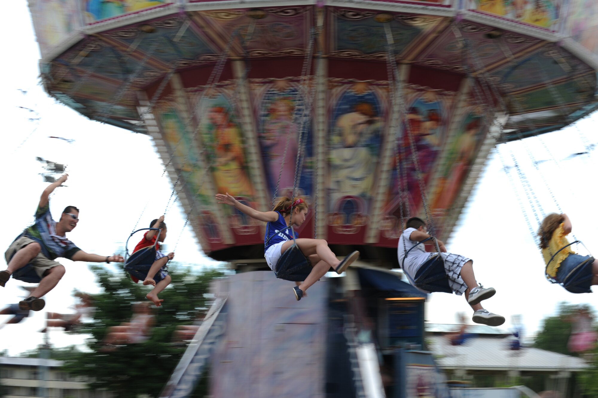 SPANGDAHLEM AIR BASE, Germany – Super Saber Appreciation Day participants ride a swing here July 4. The event included a number of activities including pony rides, a carousel and swings, and two bouncy castles were available for younger children. The 52nd Force Support Squadron sponsored the event to celebrate Independence Day and show appreciation to the 52nd Fighter Wing community. (U.S. Air Force photo by Senior Airman Matthew B. Fredericks/Released)