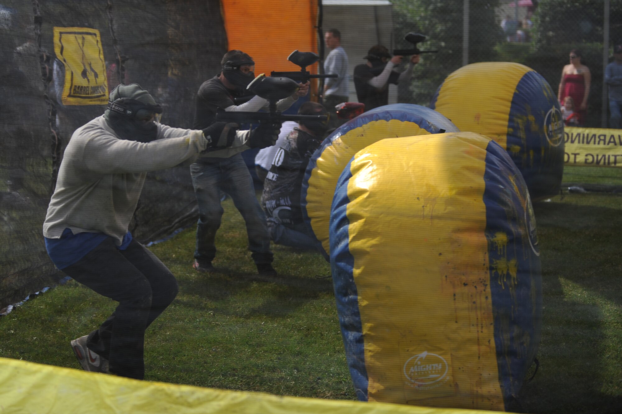 SPANGDAHLEM AIR BASE, Germany – Super Saber Appreciation Day participants engage in a paintball war on an obstacle course here July 4. The event included a number of activities including pony rides, a carousel and swings, and two bouncy castles were available for younger children. The 52nd Force Support Squadron sponsored the event to celebrate Independence Day and show appreciation to the 52nd Fighter Wing community. (U.S. Air Force photo by Senior Airman Matthew B. Fredericks/Released)