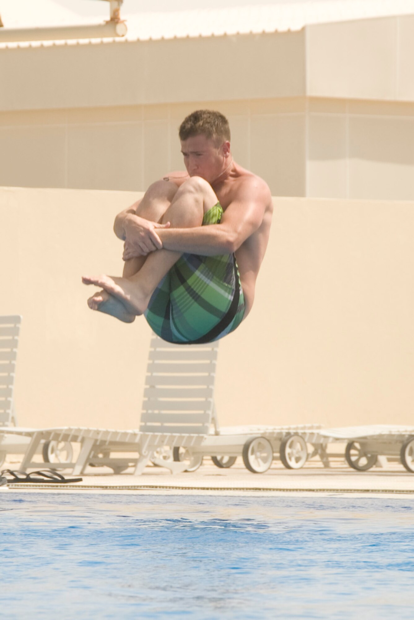 Airman 1st Class Kenway Hensley, 379th Expeditionary Civil Engineer Squadron, won first place in the Biggest Splash Contest July 4, 2012 in Southwest Asia. The Independence Day’s festivities included a 5K run, steak grilling, stand-up comedians and an R&B cover band. (U.S. Air Force photo/Senior Airman Bryan Swink)