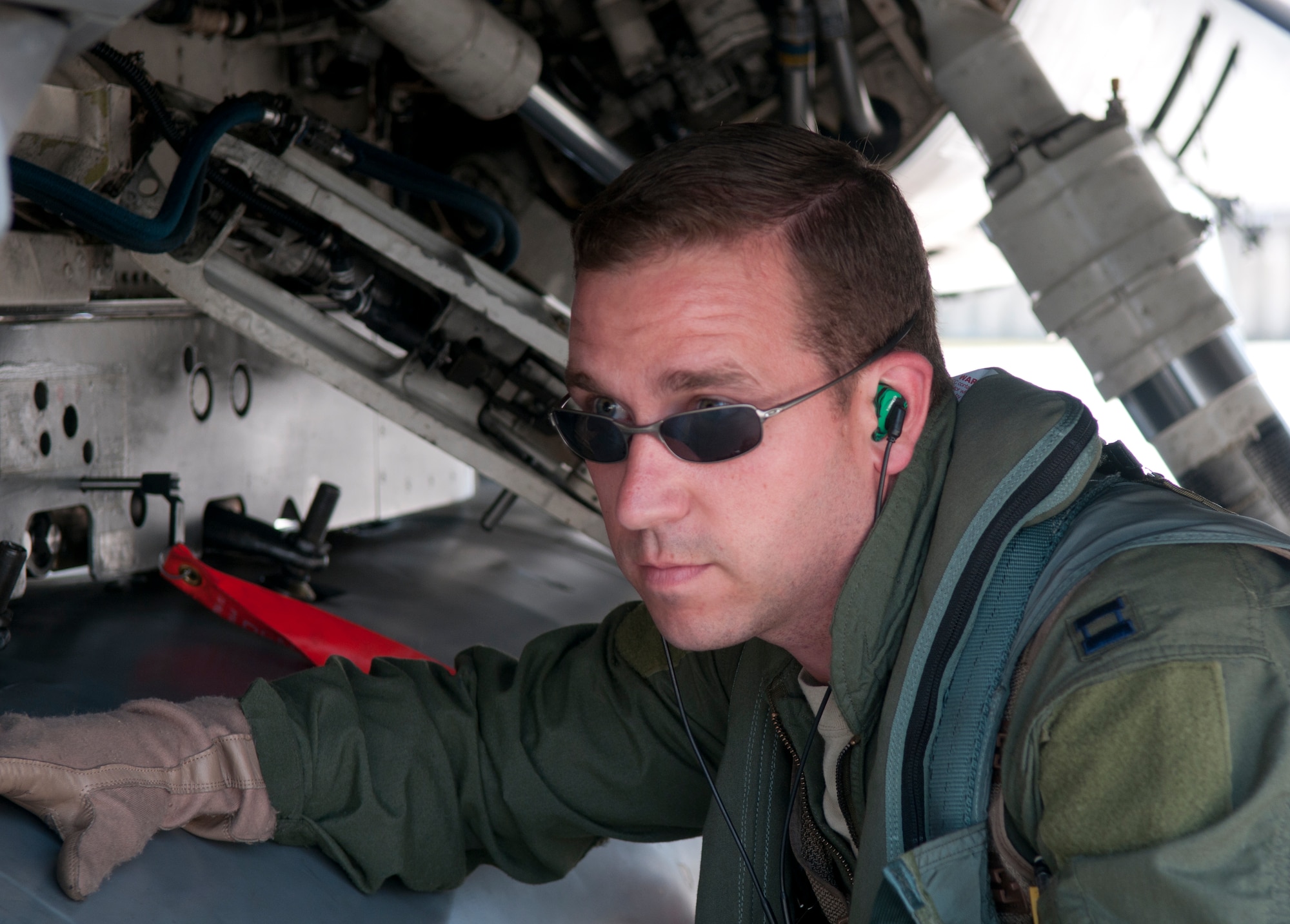 Capt. Joshua Boudreaux, 31st Operations Support Squadron, inspects an F-16 Fighting Falcon before a training flight July 2 at Aviano Air Base, Italy. Boudreaux was selected for a 2 year tour as part of the Thunderbirds. (U.S. Air Force photo/Airman 1st Class Briana Jones)
