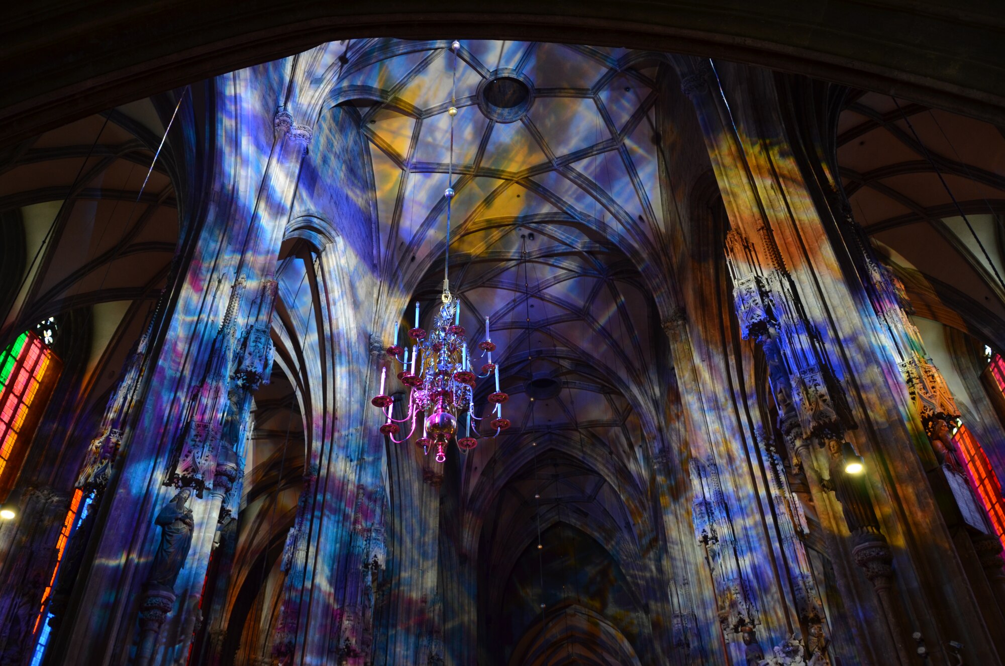 Sunlight, tinted by massive stained-glass windows, flows across stonework and sculptures at Saint Stephen's Cathedral.  Dedicated in 1147, the outside of the building features soaring towers and menacing gargoyles.  (U.S. Air Force photo/Capt. Erick Saks)