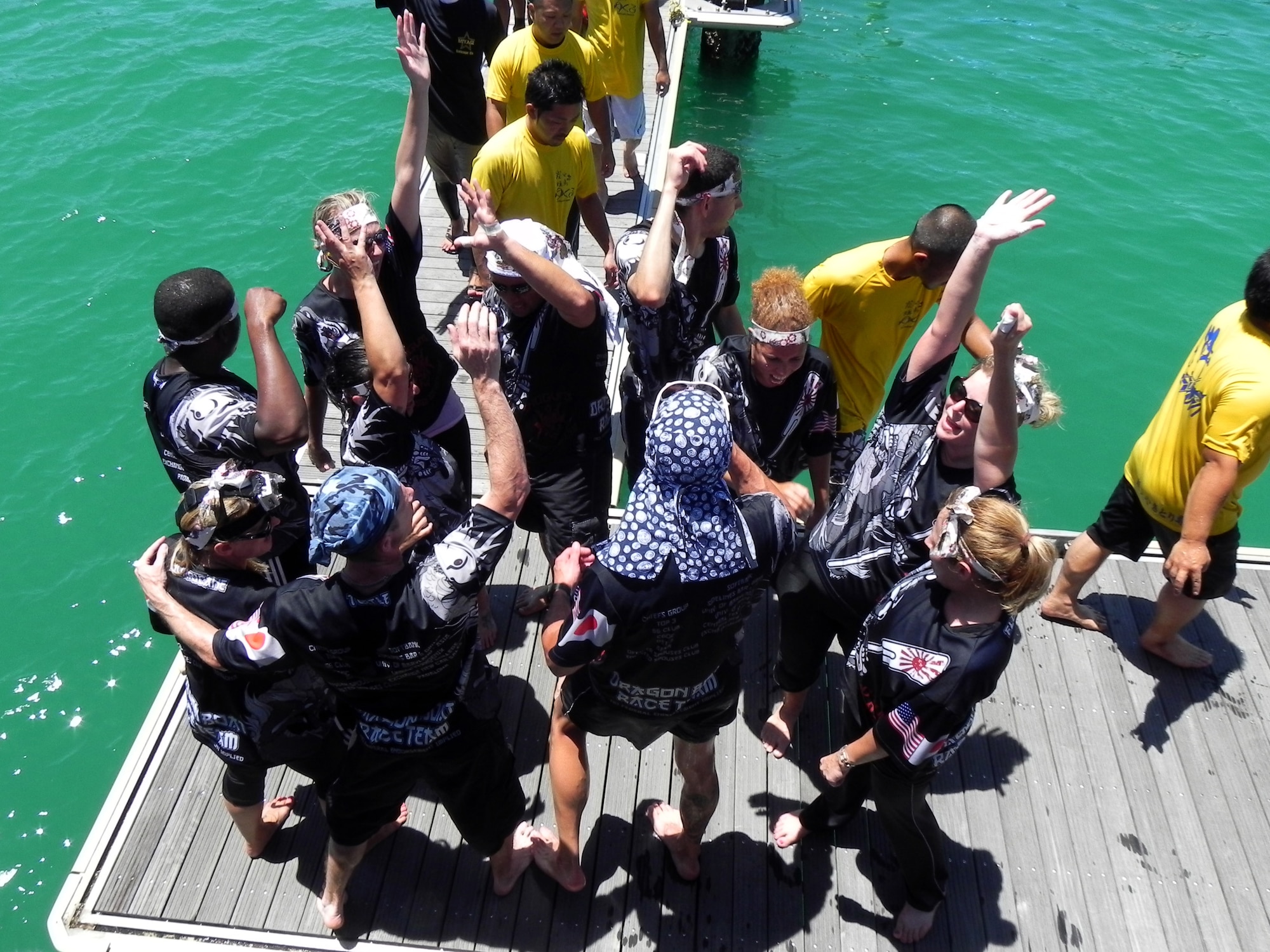 The Kadena Shogun dragon boat coed team celebrates after their race against local Okinawan coed teams during the Chatan Nirai Dragon Boat Race, June 24, 2012. Though the Kadena Shogun’s didn’t make it to the finals, they went to not only compete, but to also show the bilateral support and respect the U.S. military has for their Okinawan hosts. (U.S. Air Force photo/Sayaka Kawatake)