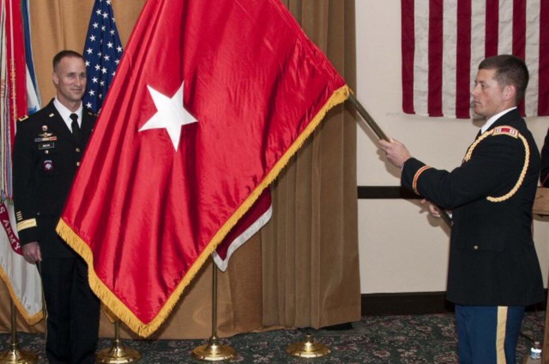 SAN FRANCISCO, -- Capt Chris Herold unfurls the one-star-flag of BG Mike Wehr at a Frocking Ceremony March 15, 2012.
