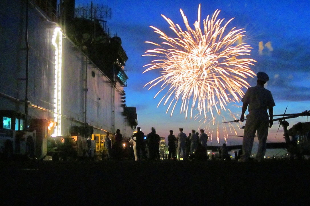 Sailors and Marines on the flight deck of the amphibious assault ship USS Wasp enjoy a fireworks display during Fleet Week 2012 in Boston, June 28, 2012. The eight-day event, which coincides with the commemoration of the War of 1812, hosts service members from the Navy, Marine Corps and Coast Guard, and coalition ships from around the world. 
