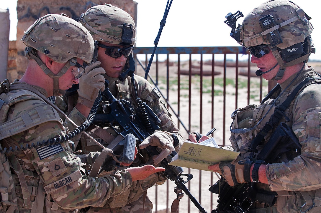 U.S. Army 2nd Lt. Nicholas Prieto, center, talks with U.S. Army Spc. Jonathan Myers, right, and U.S. Army Pfc. Blaze Glocar, left, as they call in air support during a firefight with insurgents in Afghanistan's Ghazni province, June 30, 2012. Prieto,  a platoon leader, Myers, a forward observer, and Glocar, a radioman, are assigned to the 82nd Airborne Division's 1st Battalion, 504th Parachute Infantry Regiment, 1st Brigade Combat Team.