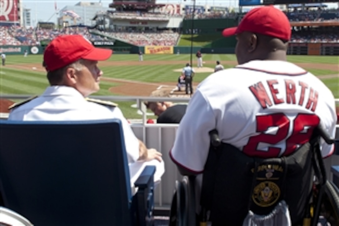 Navy Adm. James A. Winnefeld Jr., vice chairman of the Joint Chiefs of Staff, speaks with a wounded warrior during the Washington Nationals game against the San Francisco Giants in Washington, D.C., July 4, 2012.