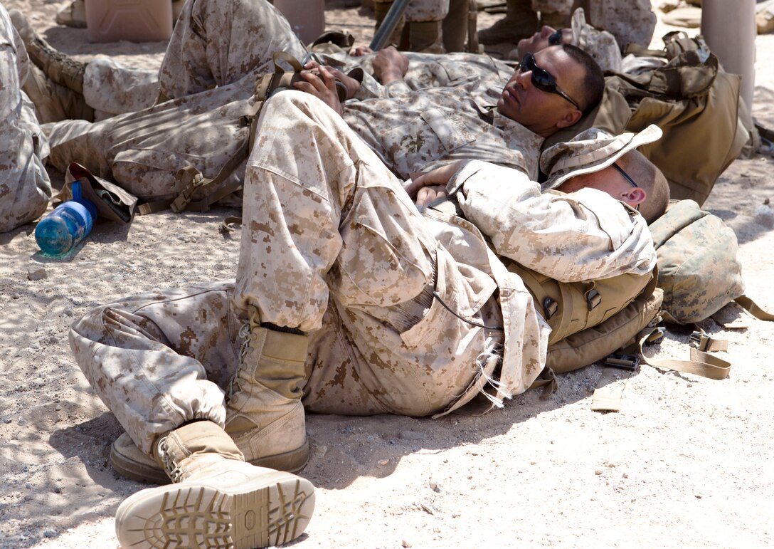 Marines from Weapons Company, 2nd Battalion, 25th Marine Regiment, rest under shade in between firing practice Light Anti-Armor Weapon rounds on Range 109. Javelin Thrust is an annual large-scale exercise here which allows active and reserve Marines and sailors from 38 different states to train together as a seamless Marine Air Ground Task Force.