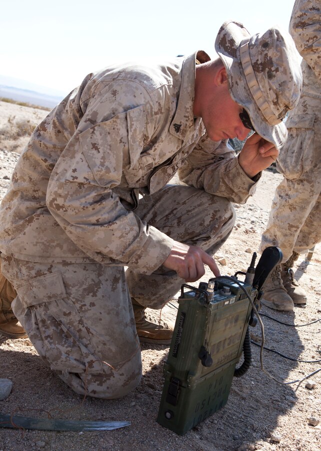 Cpl. Joshua Brown , a radio operator with Communications Company, 4th Light Armored Reconnaissance Battalion, 4th Marine Division, checks the communication capabilties of a PRC-119 radio supported via a field expedient antenna at Range 500A during Exercise Javelin Thrust 2012. Javelin Thrust is an annual large-scale exercise here which allows active and reserve Marines and sailors from 38 different states to train together as a seamless Marine Air Ground Task Force.