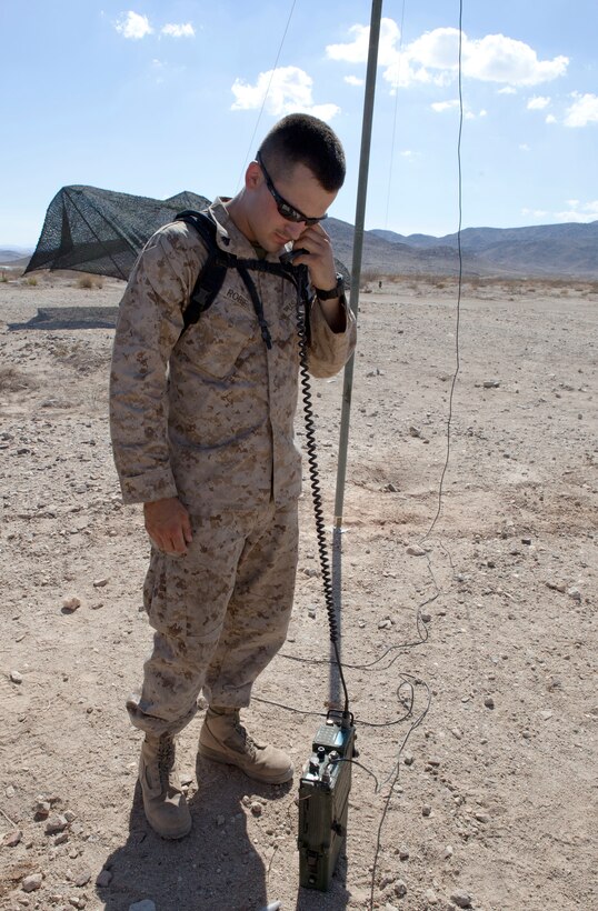 Cpl. Joshua Robie, a field wireman with 25th Marine Regiment, checks the communication capabilties of a PRC-119 radio supported via a field expedient antenna at Range 500A during Exercise Javelin Thrust 2012. Javelin Thrust is an annual large-scale exercise here which allows active and reserve Marines and sailors from 38 different states to train together as a seamless Marine Air Ground Task Force.