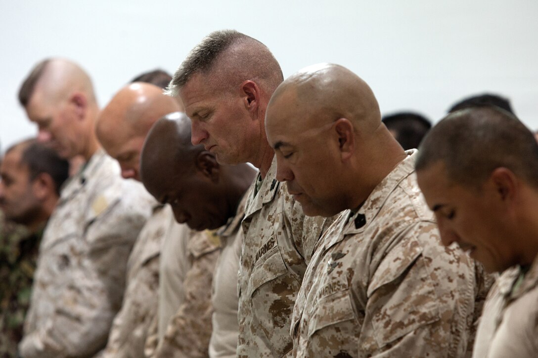 U.S. Marine Col. Roger B. Turner Jr. and Sgt. Maj. Alberto Ruiz, the commanding officer and sergeant major of Regimental Combat Team 5, and special guests, bow their heads in during a transfer of authority ceremony here, July 5, 2012. Since their activation in 1917, 5th and 6th Marine Regiments have courageously fought for America, most notably in World War I when they fought side-by-side in the bloody Battle of Belleau Wood. In December 2011, Regimental Combat Team 6 arrived in northern Helmand province to support Operation Enduring Freedom, joining RCT-5 on the same battlefield for the first time in 94 years. This historic partnership is now coming to a close.