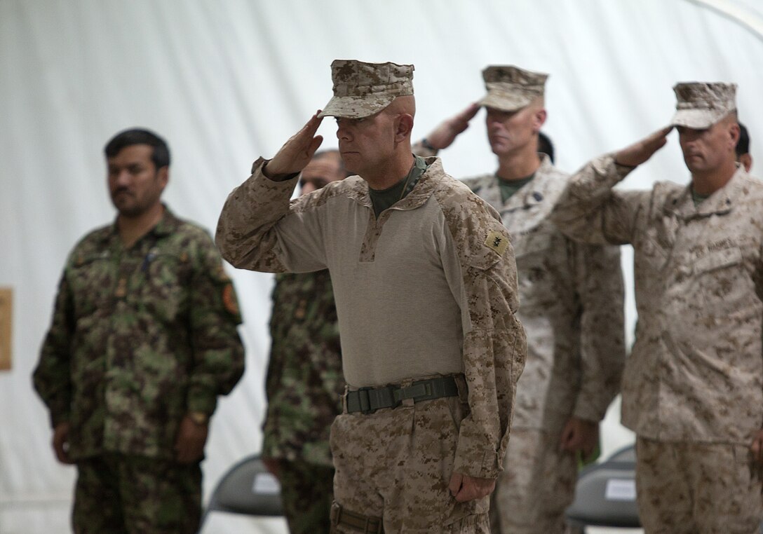 U.S. Marine Maj. Gen. David Berger, the commanding general of 1st Marine Division (Forward), salutes the colors during a transfer of authority ceremony here, July 5, 2012. Since their activation in 1917, 5th and 6th Marine Regiments have courageously fought for America, most notably in World War I when they fought side-by-side in the bloody Battle of Belleau Wood. In December 2011, Regimental Combat Team 6 arrived in northern Helmand province to support Operation Enduring Freedom, joining RCT-5 on the same battlefield for the first time in 94 years. This historic partnership is now coming to a close. Colonel Roger B. Turner Jr. and Sgt. Maj. Alberto Ruiz, the commanding officer and sergeant major of RCT-5, cased the colors of ‚Fighting Fifth‚ and transferred authority of their area of operations to Col. John R. Shafer and Sgt. Maj. Jamie Deets, the commanding officer and sergeant major of RCT-6 here, July 5.