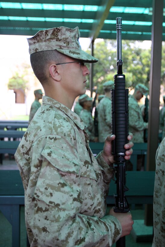 A recruit of Company E, 2nd Recruit Training Battalion, stands with his issued M16-A4 service rifle June 18 aboard Marine Corps Recruit Depot San Diego. Each recruit is issued a rifle that they will take responsibility for throughout recruit training.