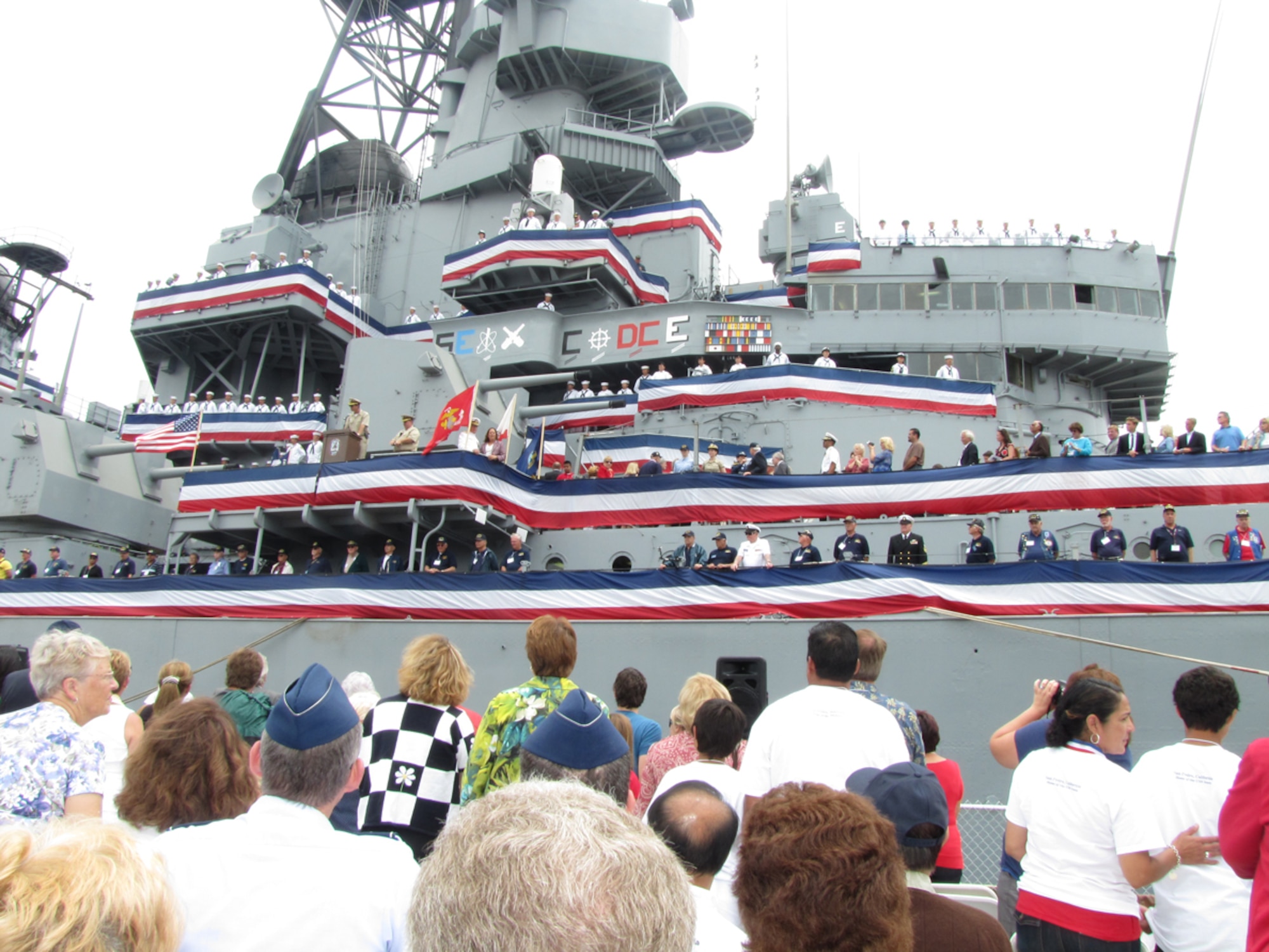 USS Iowa veteran alumni, Pacific Battleship Center staff, senior military officers, and Iowa state and local government officials attend a commissioning ceremony aboard the USS Iowa, July 4.   Launched in 1942 and decommissioned for the last time in 1990, the USS Iowa was towed from San Francisco Bay to its new home in San Pedro. The battleship opens to the public for tours, July 7. (Photo by Lynn Kirby)