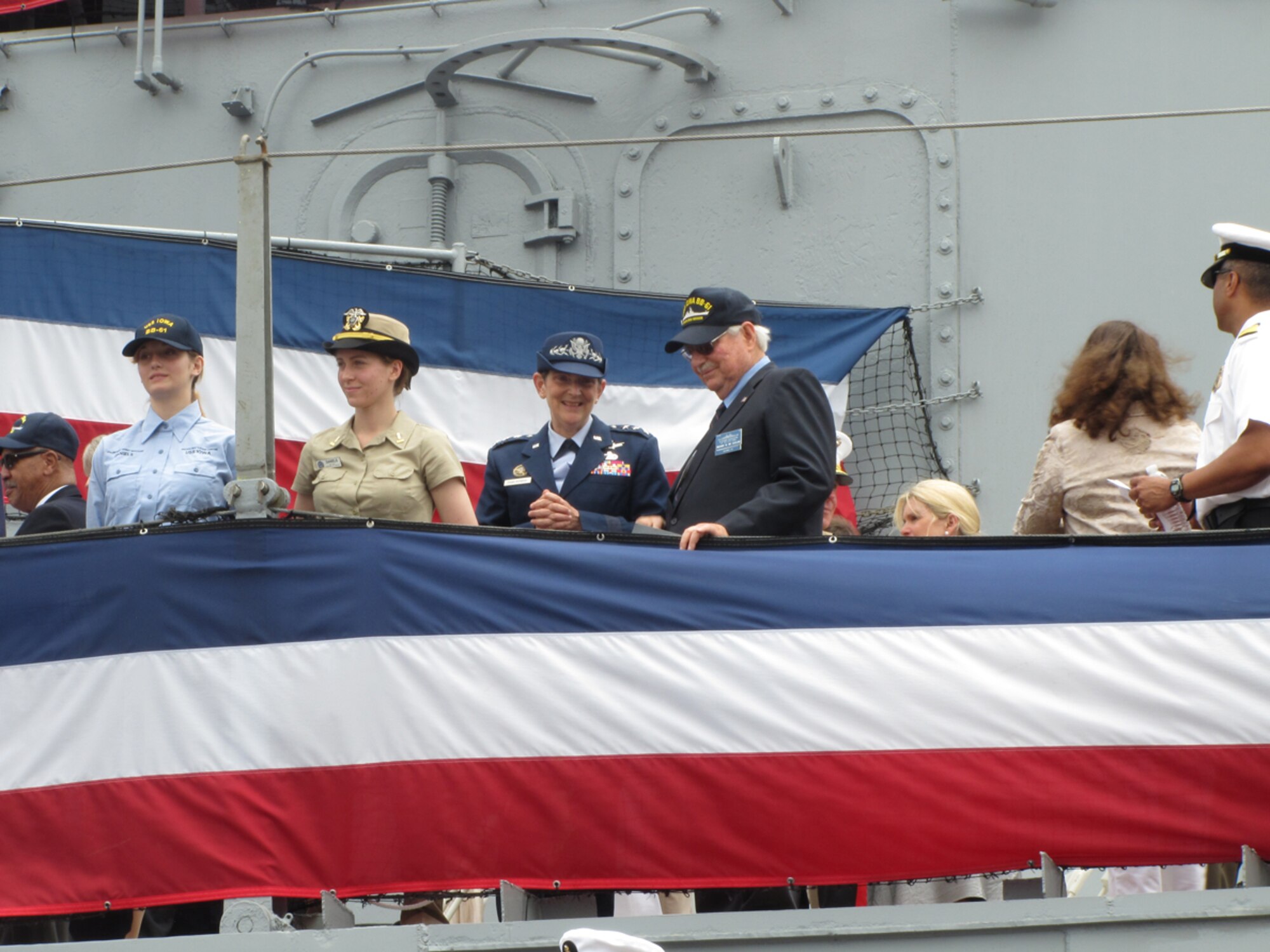 Space and Missile Systems Center Commander Lt. Gen. Ellen Pawlikowski stands alongside USS Iowa veteran alumni, Pacific Battleship Center staff, senior military officers, and Iowa state and local government leaders to man the rails during the commissioning ceremony July 4, in San Pedro, Calif. The ceremony established the retired naval vessel as a historical center of education.  The USS Iowa opens to the public for tours on July 7. (Photo by Lynn Kirby)