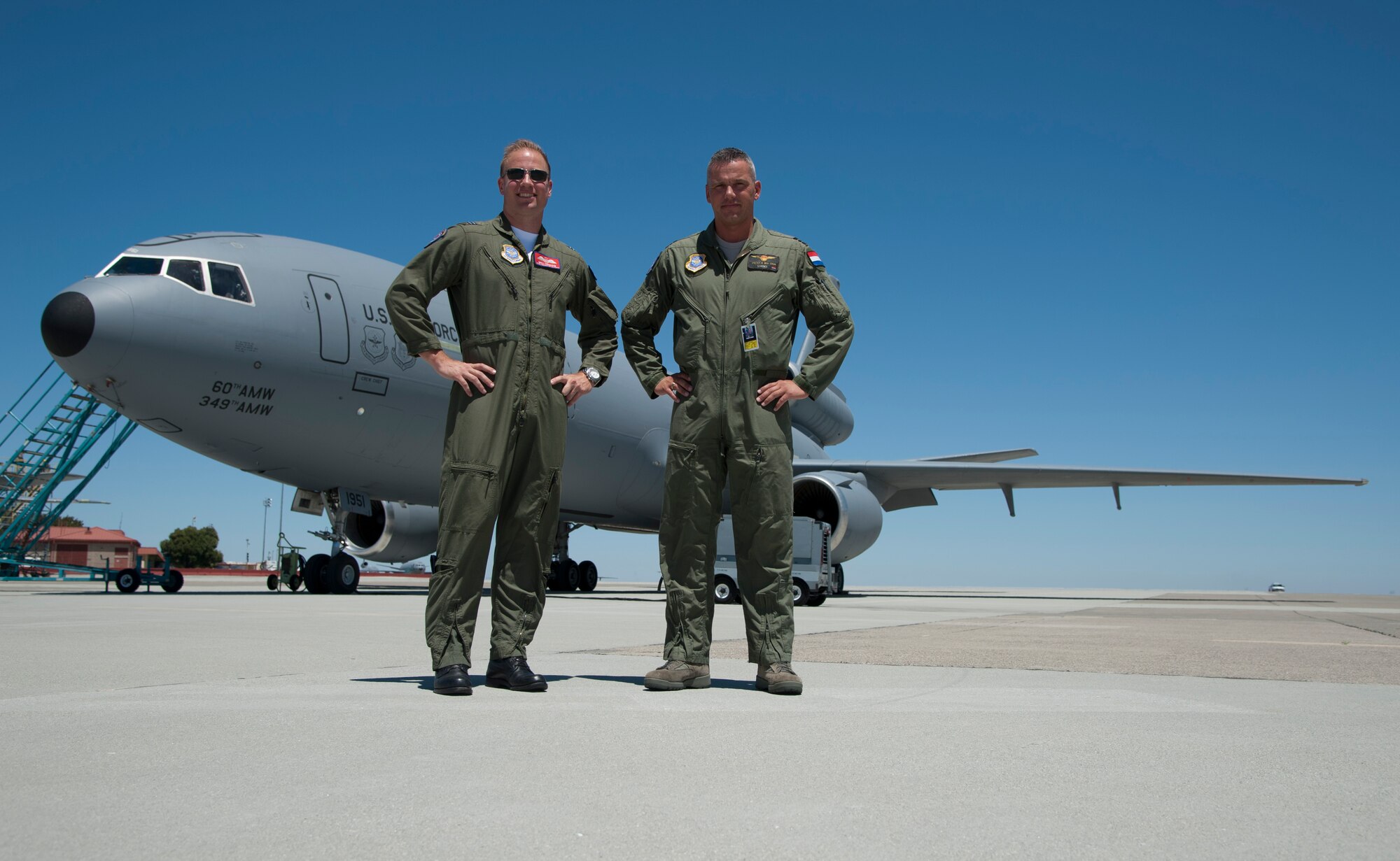 Maj. Patrick Van Dam, 9th Air Refueling Squadron pilot from the Royal Netherlands air force, and Flight Lt. Greg Ferguson, 9th ARS pilot from the Royal Australian Force, stand on the flightline June 27 near a KC-10 Extender. Van Dam and Ferguson are participating in pilot exchange program. (U.S. Air Force photo/ Airman 1st Class Nicole Leidholm)