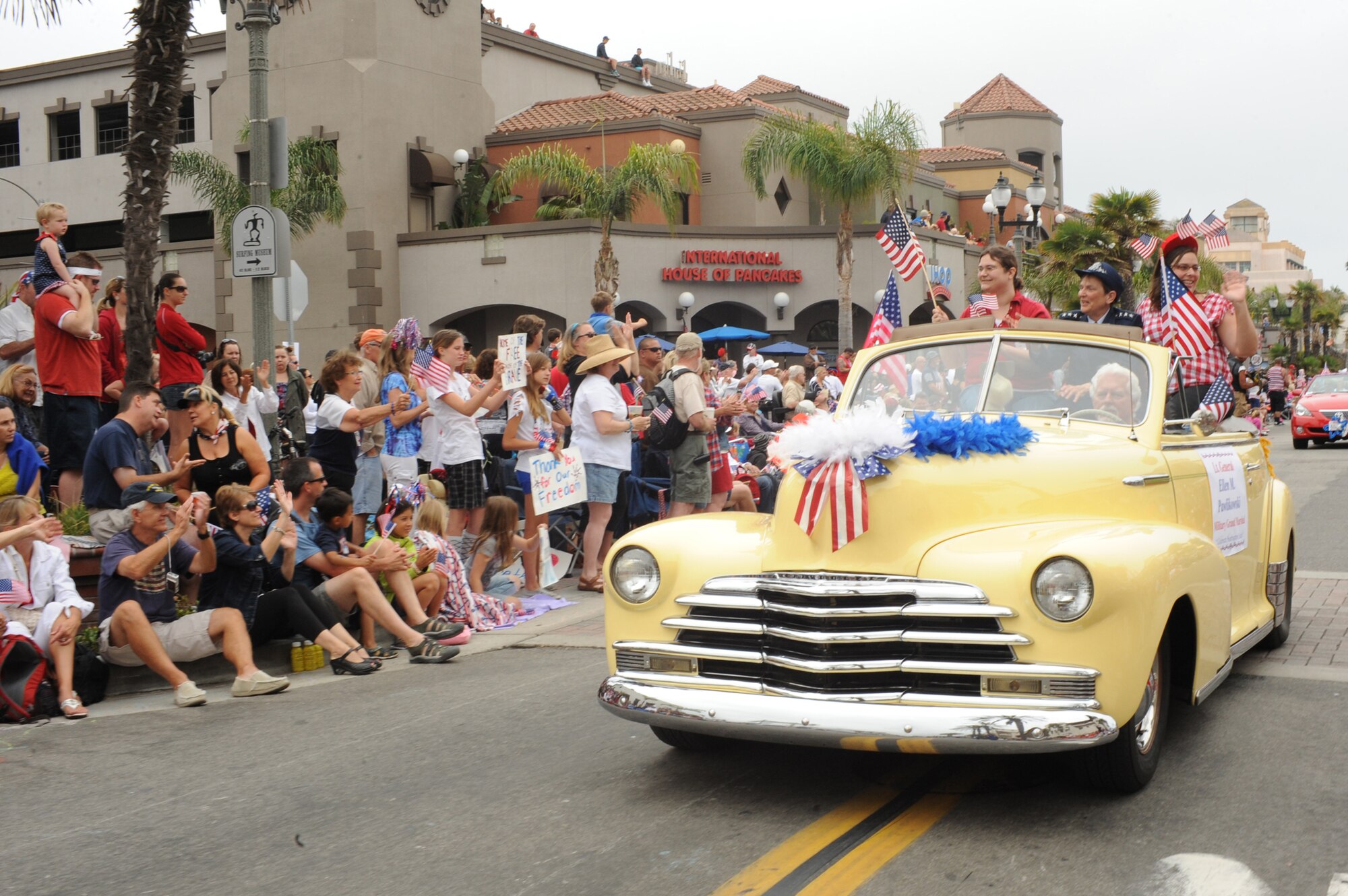 Lieutenant Gen. Ellen Pawlikowski, SMC commander, and her daughters Jennifer and Laura wave to the crowds during the Huntington Beach 4th of July parade. The general was this year’s military grand marshal. Approximately 300,000 people attended this year’s parade. (Photo by Sarah Corrice) 