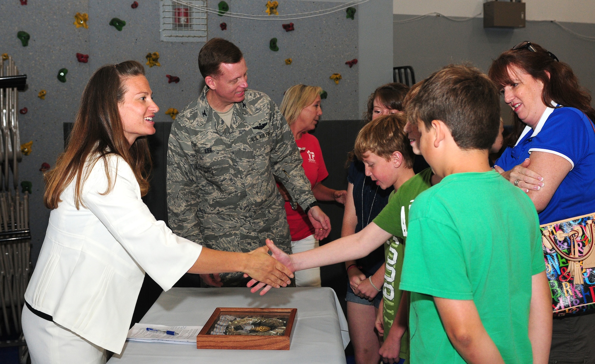 Jennifer Kelchner, a Paralympics gold medalist speaks to Col. Douglas Lee, 9th Reconnaissance Wing vice commander, and his family at the Youth Center at Beale Air Force Base, Calif., June 27, 2012. Kelchner kicked off Beale's Olympic Day with her story of winning a gold medal at the 1998 Winter Olympics in Japan. (U.S. Air Force photo by Senior Airman Allen Pollard)