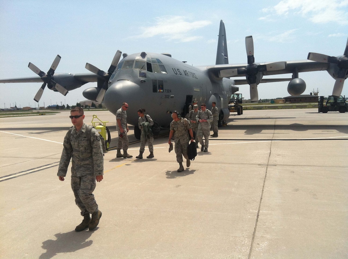 Members of 146th Airlift Wing Maintenance hitch a ride on a C130-H from Colorado Springs, Colo. to Cheyenne, Wyo. July 5, 2012, where U.S. Forest Service continues to battle the wildfires with MAFFS (Modular Airborne Firefighting Systems) operations in the Rocky Mountain region.   MAFFS efforts have been focused on the Squirrel Creek fire about 70 miles west of Cheyenne. (U.S. Air Force Photo/Senior Airman Nicholas Carzis)