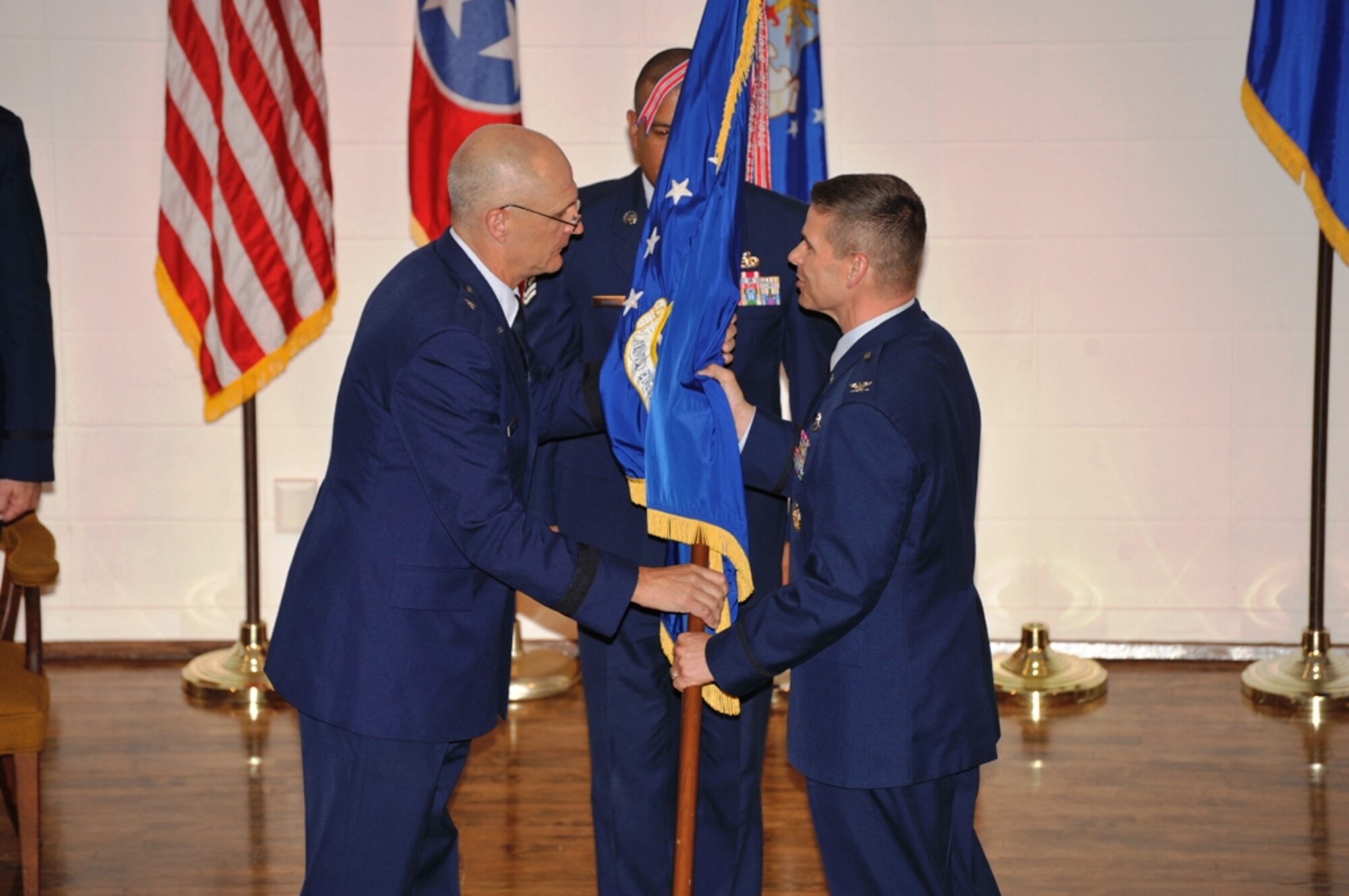 Air Force Test Center Commander Brig. Gen. Arnold Bunch Jr., left, presents the flag for the newly-redesignated Arnold Engineering Development Complex, Arnold Air Force Base, Tenn., to Commander Col. Raymond G. Toth during a change of command ceremony July 6 at the University of Tennessee Space Institute. (Photo by Rick Goodfriend)