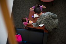 Master Sgt. Shane Chandler, Air Force Special Operations Command logistics office, serves his daughters, Cara, 2, and Leighlin, 5, drinks during AFSOC's Bring your Child to Work Day, June 29, 2012, at Hurlburt Field, Fla. (U.S. Air Force photo by Staff Sgt. David Salanitri) 
