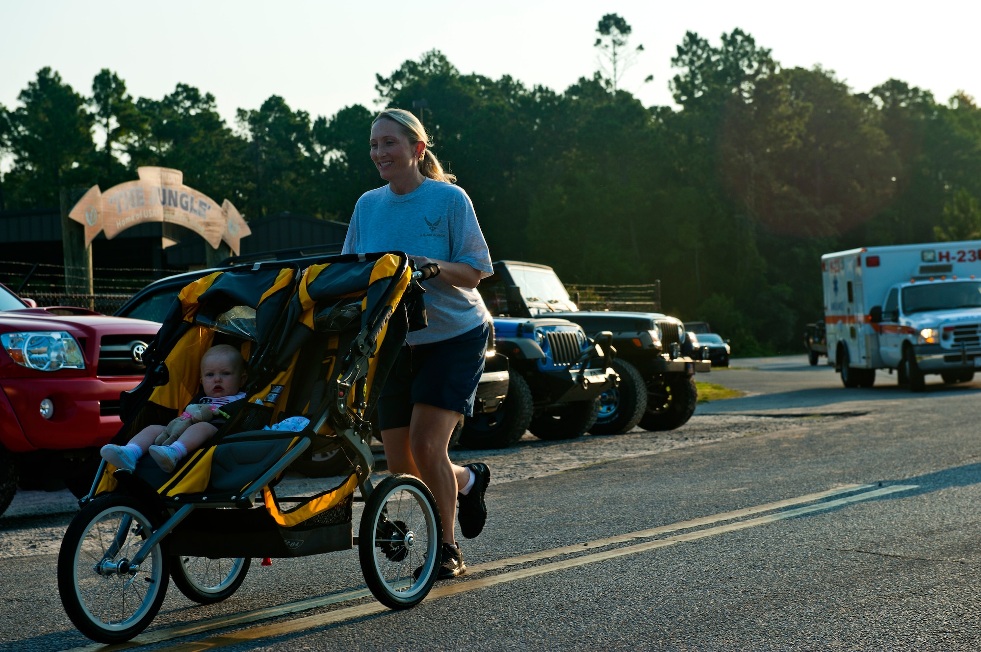 Capt. Kristen Duncan, Air Force Special Operations Command Public Affairs, jogs with her daughter, Luci, June 29, 2012, at Hurlburt Field, Fla. AFSOC hosted Bring Your Child to Work Day. (U.S. Air Force photo by Staff Sgt. David Salanitri)