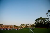 Airmen from Air Force Special Operations Command perform sit ups during a morning physical training session with their children during Bring Your Child to Work Day, June 29, 2012, at Hurlburt Field, Fla. After sit ups, Airmen ran or walked with their children in a modified formation. (U.S. Air Force photo by Staff Sgt. David Salanitri) 