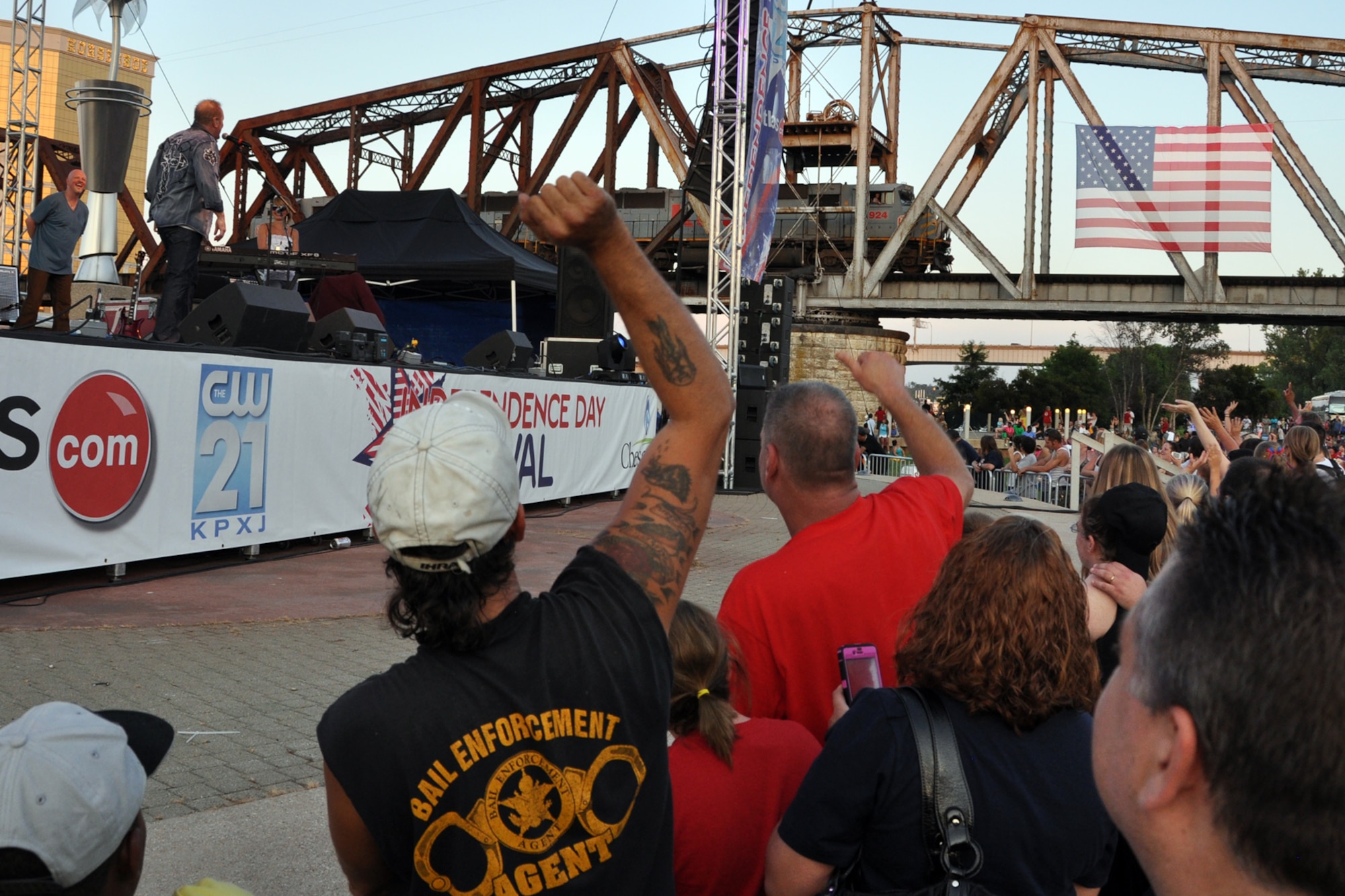 American country music singer Collin Raye raises the roof when he talks to a train engineer who made a little too much noise while he was performing for a crowd of thousands during a concert commemoration of our nation’s birthday at the Independence Day celebration in Shreveport, La., July 4, 2012. The celebration at Riverview Park featured many types of food and beverage vendors, a concert and a flyover by a B-52 Stratofortress from the 307th Bomb Wing at Barksdale Air Force Base. La. (U.S. Air Force photo by Master Sgt. Jeff Walston)