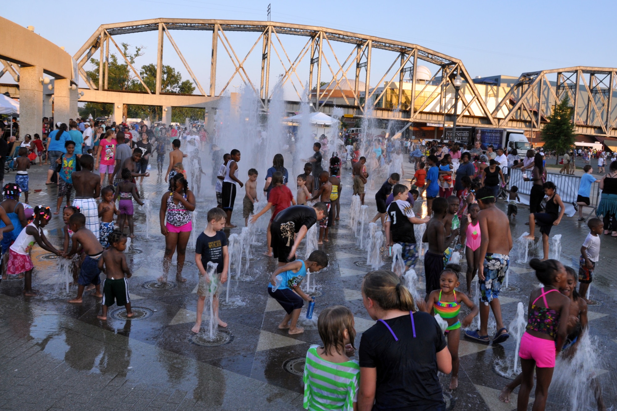 Hundreds of children enjoyed the cooling waters of the fountains during the Independence Day celebration in Shreveport, La., July 4, 2012. The celebration at Riverview Park in downtown Shreveport featured many types of food and beverage vendors, a musical concert, fireworks, and a flyover by a B-52 Stratofortress from the 307th Bomb Wing at Barksdale Air Force Base. La. (U.S. Air Force photo by Master Sgt. Jeff Walston)