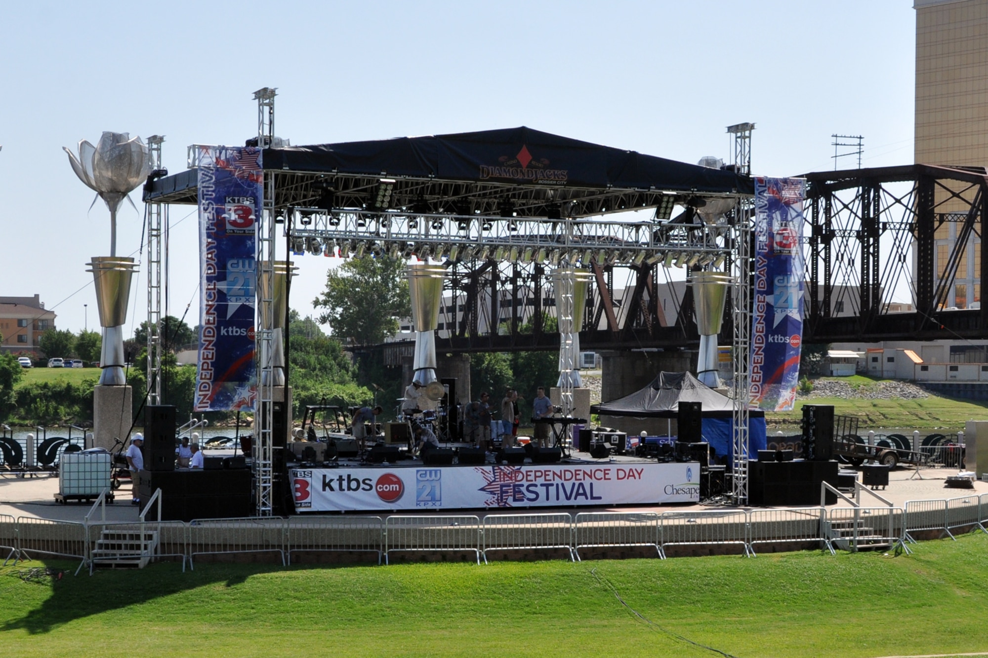 Stagehands setup musical and electrical equipment for the concert scheduled as a part of the commemoration of the nation’s birthday during the Independence Day Festival in Shreveport, La., July 4, 2012. The celebration at Riverview Park featured many types of food and beverage vendors, music from Collin Raye, and a flyover by a B-52 Stratofortress from the 307th Bomb Wing at Barksdale Air Force Base. La. (U.S. Air Force photo by Master Sgt. Jeff Walston)
