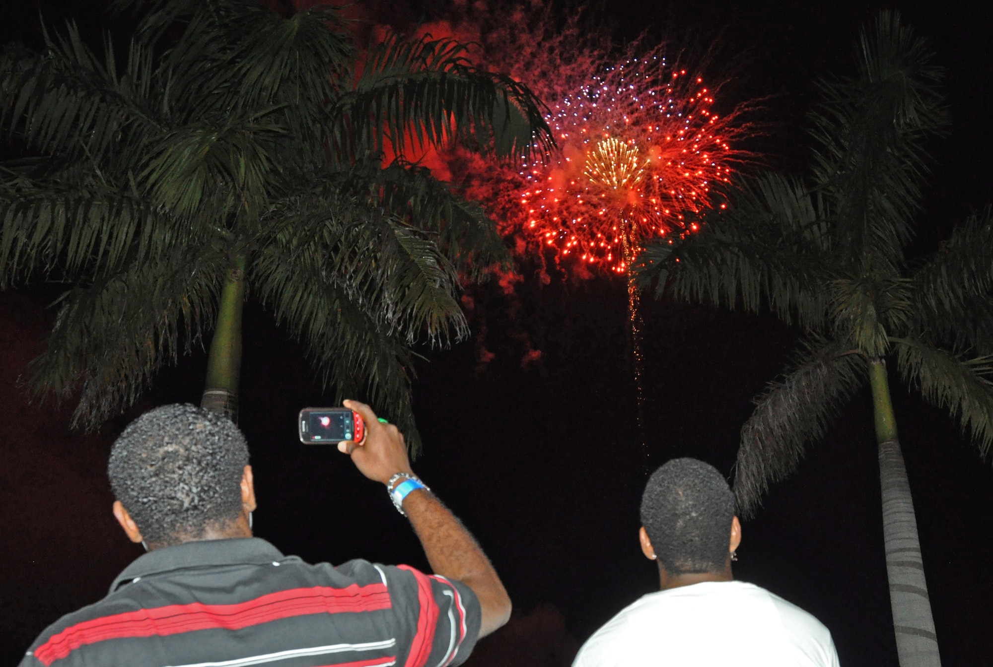 Homestead Air Reserve Base 4th of July celebration attendee pauses to capture a video of the bases firework show.  (U.S. Air Force photo/Senior Airman Jacob Jimenez)