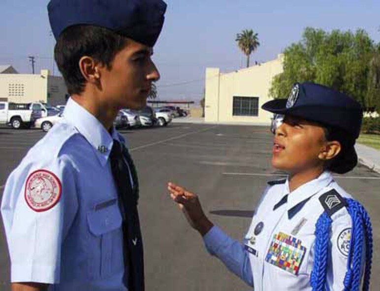 Sixteen-year-old Mari Orona, Air Force JROTC cadet captain and wing commander from Rancho Verde High School, addresses a subordinate during an open-ranks inspection at March Air Reserve Base last month. The students were participating in a March ARB-sponsored, two-week leadership school. (U.S. Air Force photo by Jale Wesley)