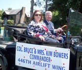 Kim and Col. Bruce Bowers, 446th Airlift Wing commander, ride in the colonel's 1916 Ford Model T at the Steilacomm, Wash., 4th of July parade. (U.S. Air Force photo by Master Sgt. Yvette Larson)