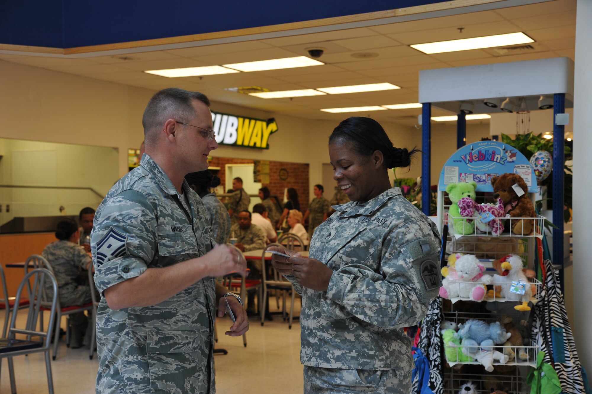 Senior Master Sgt. James Wadas, 315th Training Squadron first sergeant, hands a $20 AAFES gift card to an Army staff sergeant, July 2. The bases first sergeants came together to show apprecaition to the military members working on base. (U.S. Air Force photo/Airman 1st Class Erica Flores)