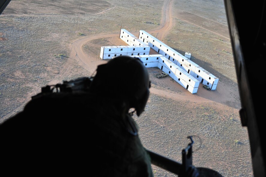 U.S. Air Force Staff Sgt. Casey Spang, 20th Special Operations Squadron flight engineer, fires a 50 caliber weapon out the back of a CV-22 Osprey while flying over Melrose Air Force Range, N.M., July 5, 2012. The 20 SOS conducted a routine training flight over Melrose. (U.S. Air Force photo by Airman 1st Class Alexxis Pons Abascal) 