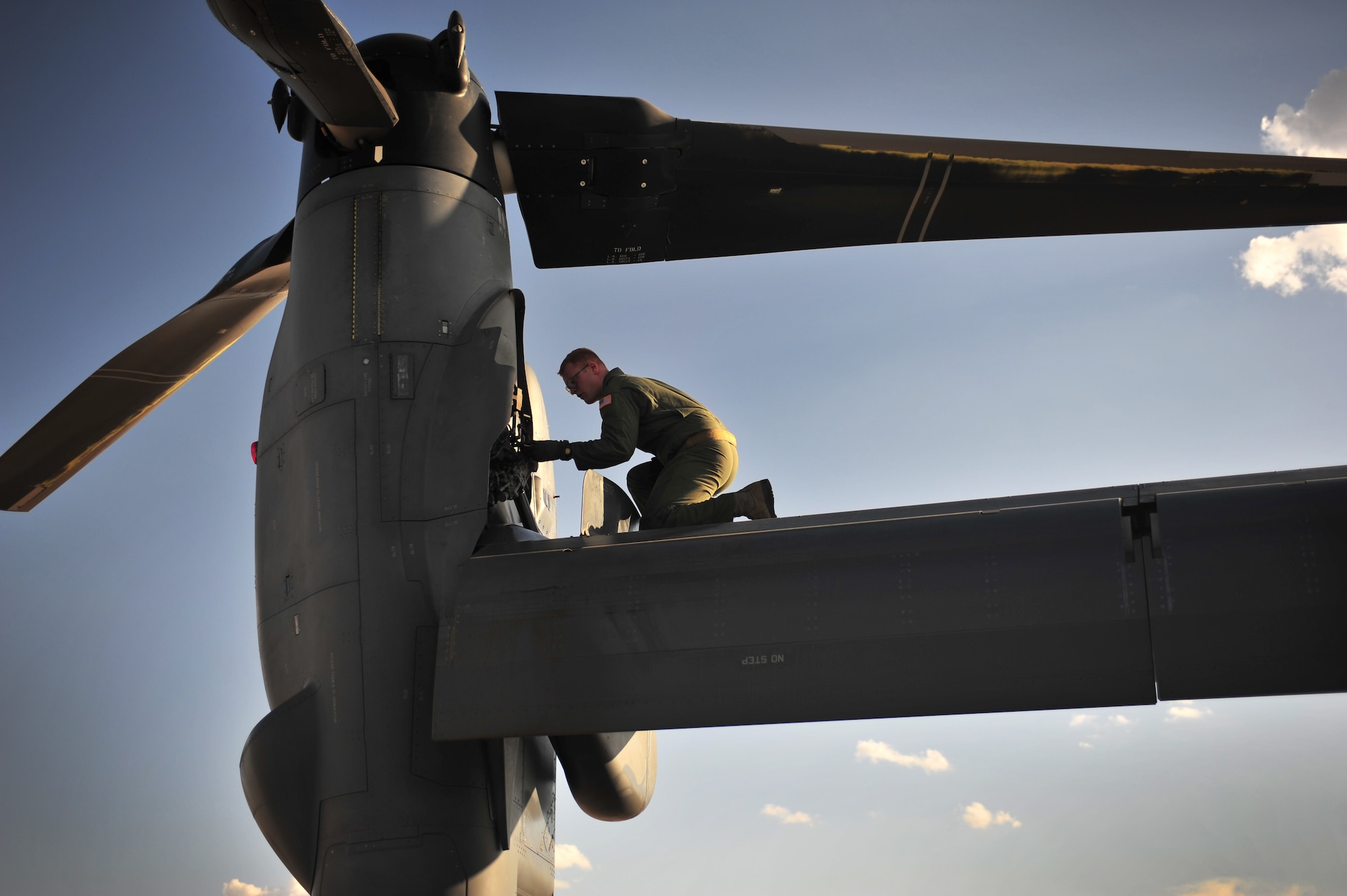 U.S. Air Force Staff Sgt. Casey Spang, 20th Special Operations Squadron flight engineer, inspects one of the tilt-rotors on a CV-22 Osprey prior to takeoff on the flightline at Cannon Air Force Base, N.M., July 5, 2012. The 20 SOS conducted a routine training flight over Melrose Air Force Range, N.M. (U.S. Air Force photo by Airman 1st Class Alexxis Pons Abascal)