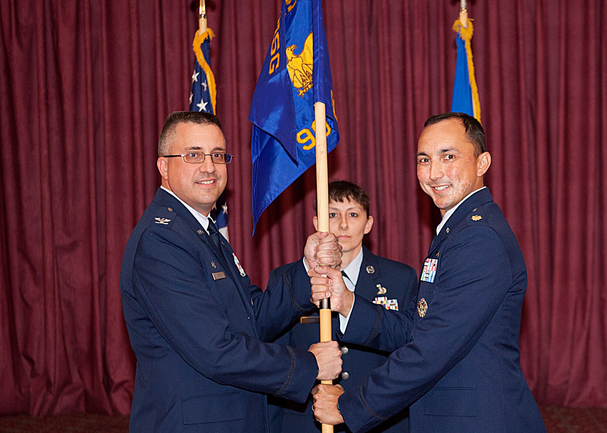 Colonel Timothy Dodge, 90th Mission Support Group commander, passes command to Maj. John Dines, incoming commander of the 90th Communications Squadron, during a change of command ceremony June 29 at Trails End Club. Maj. Dines takes over command from Lt. Col. Denaughel. (U.S. Air Force photo by Matt Bilden)
