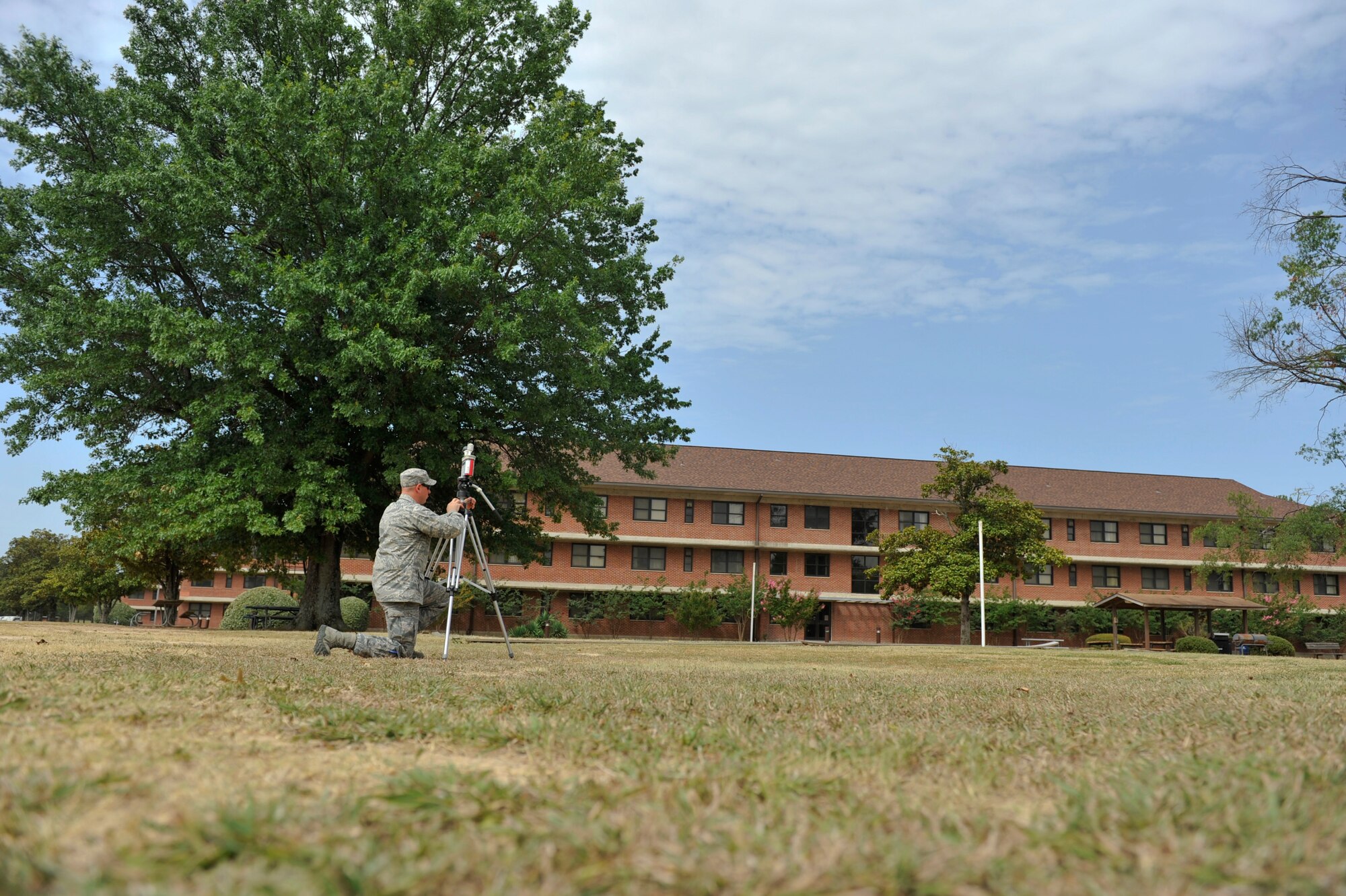 Airman 1st Class Mathew Footit, a 19th Aerospace Medical Squadron bio and enviromental technician, sets up a wet bulb globe temperature monitor July 3, 2012, at Little Rock Air Force Base, Ark. The monitor calculates temperatures, which are used to assign heat stress categories on base. (U.S. Air Force photo by Airman 1st Class  Rusty Frank)