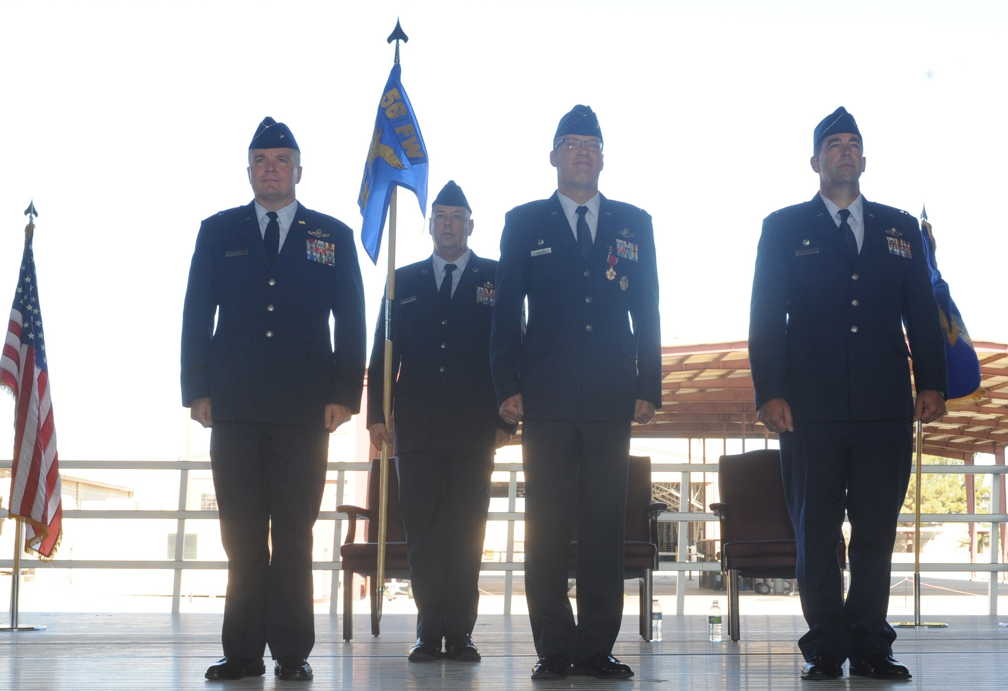 FROM LEFT: Brig. Gen. JD Harris, 56th Fighter Wing commander, and Col. Doug Miller, 56th Operations Group commander, prepare to pass the leadership of the 56th OG to Col. John Hanna at a change-of-command ceremony June 29 at Luke Air Force Base.  (U.S. Air Force photo by Airman 1st Class Devante Williams)