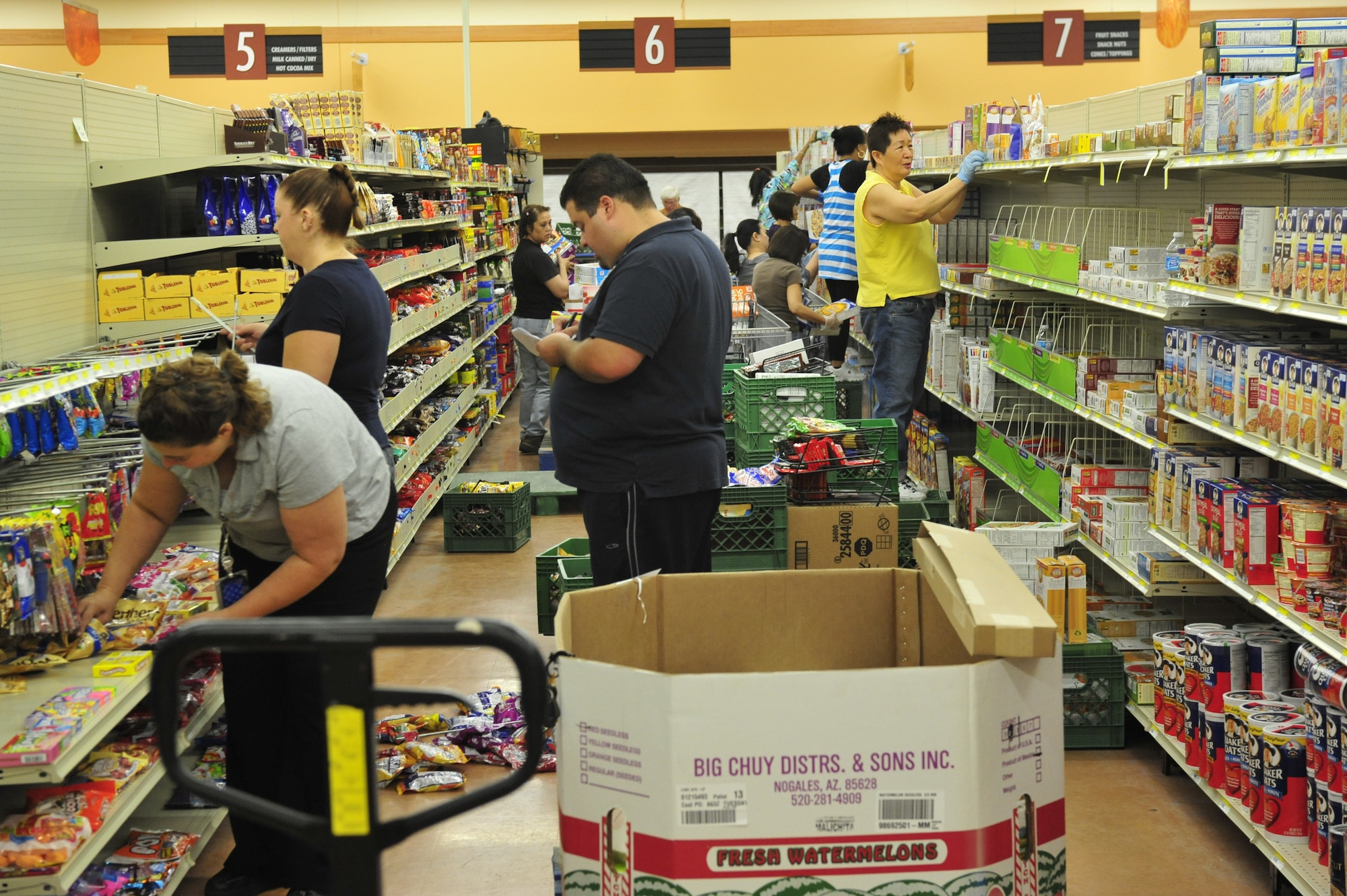 Commissary staff fill shelves according to the new floor reset plan.  (U.S. Air Force photo by Staff Sgt. Jason Colbert)