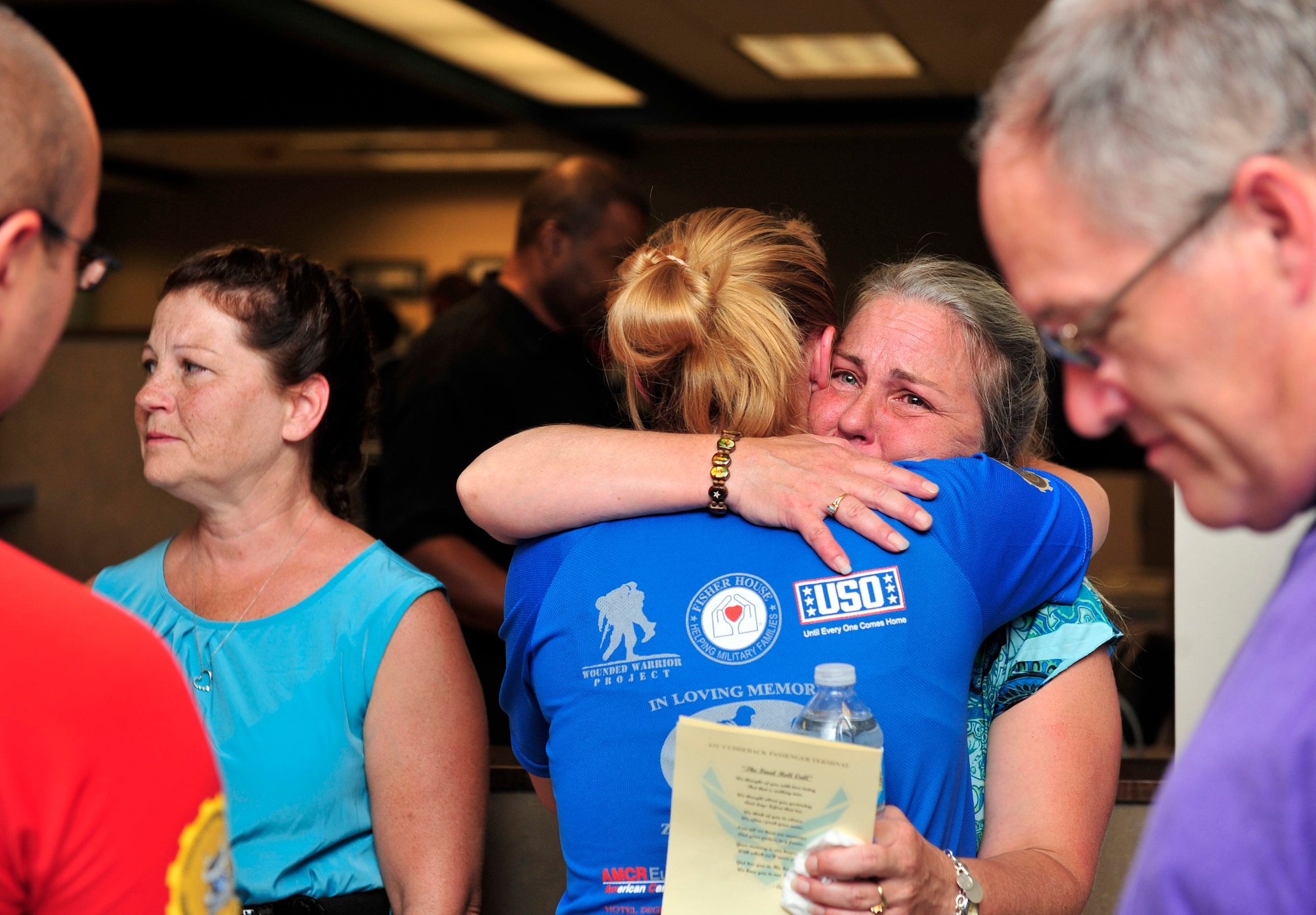 Celia Loyet hugs Staff Sgt. Ashley Rivera after a Scott Air Force Base, Ill dedicated the passenger terminal to her son Airman 1st Class Zachary Cuddeback July 6, 2012.  Rivera was a friend of Zachary’s when they were stationed at Ramstein Air Base, Germany together. Rivera and her family came all the way from her current base, Ramstein, to attend the ceremony. (U.S. Air Force photo/ Staff Sgt. Stephenie Wade)