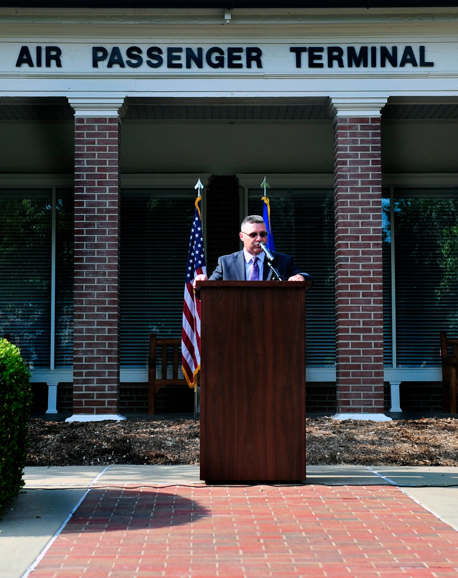 Robert Cuddeback father speaks about his son, Airman 1st Class Zachary Ryan Cuddeback July 6, 2012 during the Scott Air Force Base, Ill. passenger terminal dedication ceremony. The passenger terminal was dedicated to his son Zachary in honor of his service. Zachary was a vehicle operator assigned to Ramstein Air Base, Germany when he was mortally wounded March 2, 2011 by a terrorist while transporting Air Force Security Forces members to the airport. (U.S. Air Force photo/ Staff Sgt. Stephenie Wade)