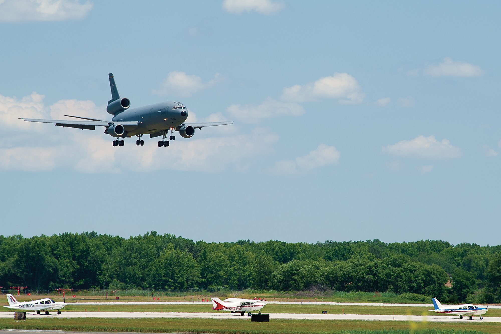 A KC-10 Stratotanker flies above several civilian general aviation aircraft as it makes its approach to land on the flightline here June 23. Nearly 50 civilian pilots flew onto the installation to participate in the mid-air collision avoidance program. (U.S. Air Force photo Shawn J. Jones)