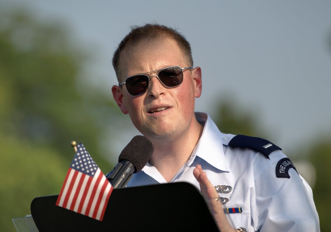 1st Lt. Pete Folliard, U.S. Air Force Heritage of America Concert Band conductor, addresses the audience during a concert at Williamsburg, Va., July 4, 2012. "I hope you're ready to get your toes tapping and your hands clapping," he said, "I bet you you're going to be singing before the night's over." (U.S. Air Force photo by Tech. Sgt. Barry Loo/Released)